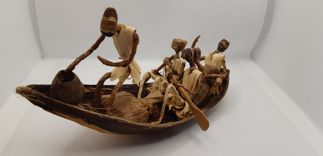 Canoe of banana tree bark with figures